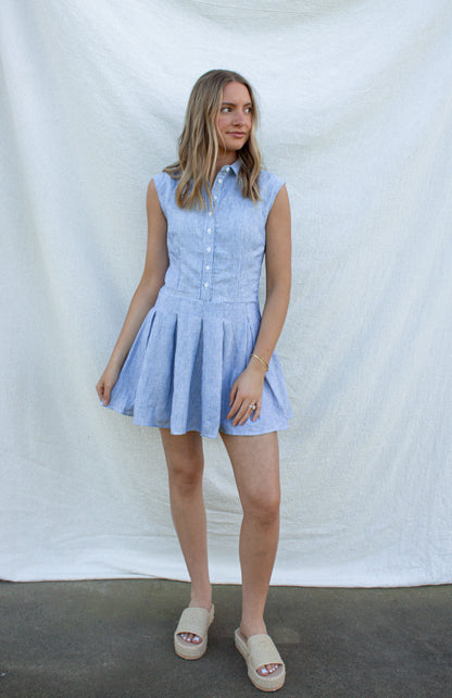 Woman wearing a light blue dress against a white background