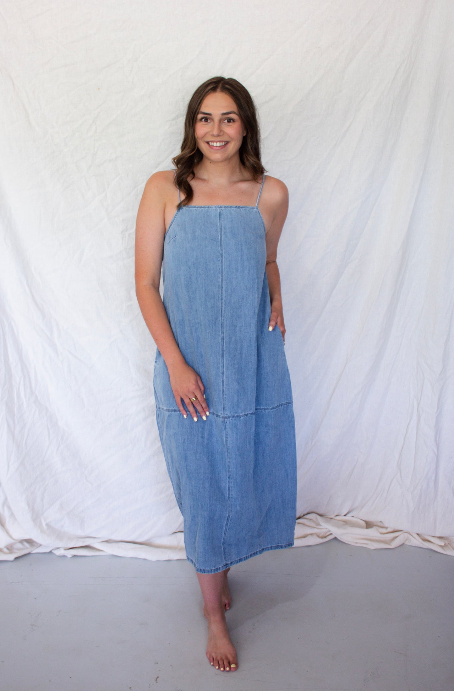 Woman wearing a blue dress against a white background
