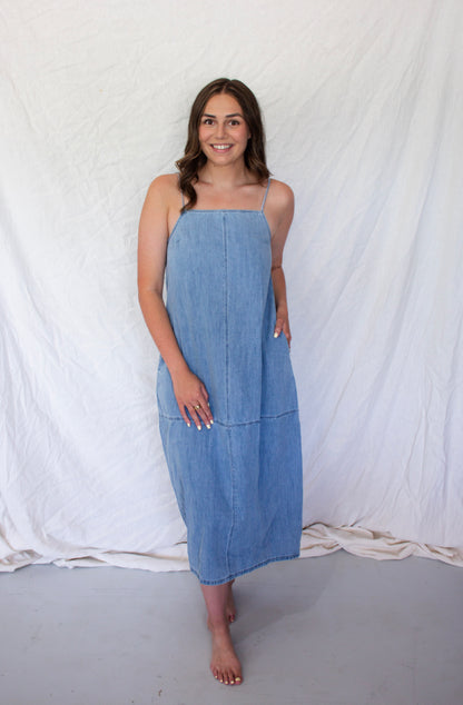 Woman wearing a blue dress against a white background